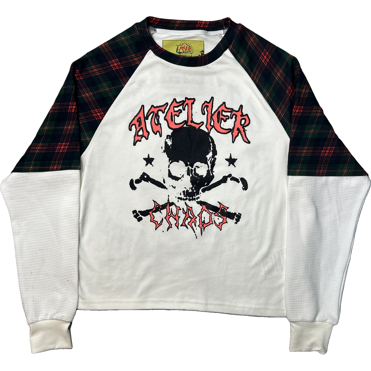 A raglan-style long-sleeve shirt with a white body, black and red graphic print featuring a skull and crossbones, and dark green plaid sleeves.